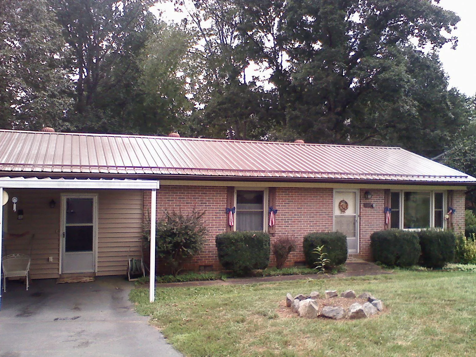 Bronze metal roof and carport on a brick ranch home — Roof Repair work by our crew in High Bridge
